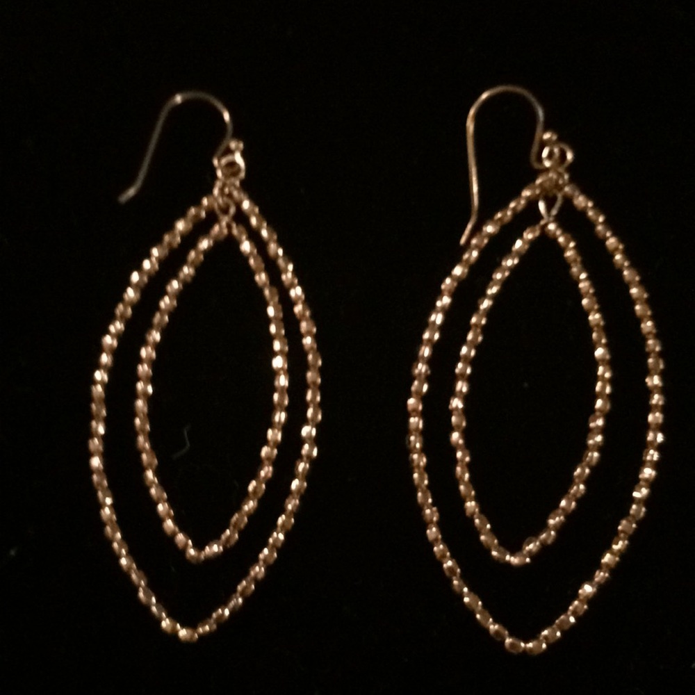Gold dangle earrings.